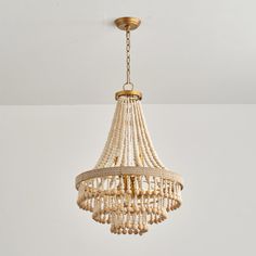 a chandelier hanging from the ceiling in a room with white walls and flooring