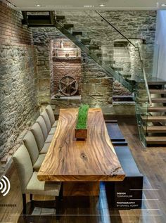 a wooden table sitting in front of a stair case