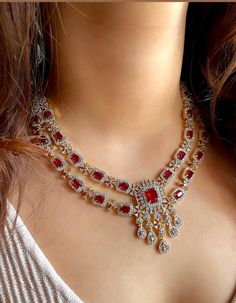 Add a touch of elegance and sophistication with this gold and silver finish necklace set in beautiful ruby red stones. The stones in this set bling and look close to the real thing. This set is sure to make heads turn!  It features an adjustable necklace and a pair of earrings. It can be paired perfectly with both ethnic and western outfits.  In case of any queries, please feel free to reach out. Happy shopping! Necklace weight: 60 gms  Length: 16 inches with an adjustable metal chain at the bac Indian Ring Ceremony, Wedding Jewelry Indian, Red Necklace Set, American Diamond Necklace Set, Indian Ring, Indian Rings, Ring Ceremony, American Diamond Necklaces, Rings Ceremony