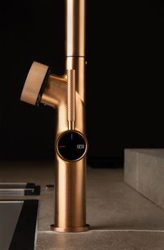 a gold colored faucet sitting on top of a counter