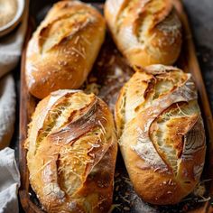 freshly baked bread sitting on top of a wooden tray