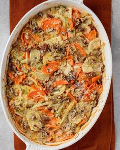 a casserole dish filled with carrots and meat