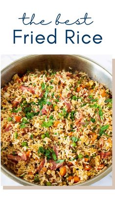 the best fried rice recipe with ham and vegetables in a pan on a white table