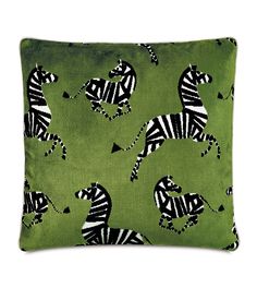 a green pillow with zebras on it