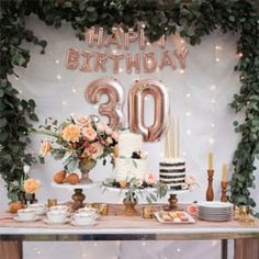 an image of a birthday party setting with cake and flowers on the table for someone's 30th birthday