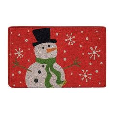 a red door mat with a snowman on it