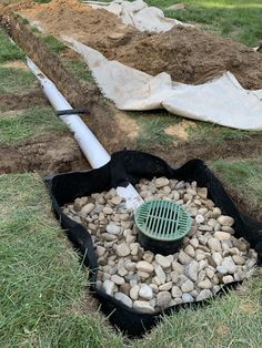 there are many different types of rocks in the yard and on the ground, including an umbrella