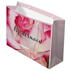 a pink rose with the words mother of the bride printed on it's shopping bag