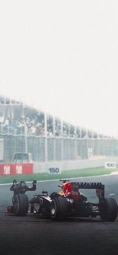 a man driving a race car around a track