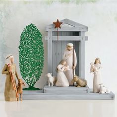 a nativity scene with figurines and trees