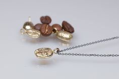 This cute little coffee bean necklace is the perfect gift for your favorite barista or for a coffee addicted friend or lover.   It might be a reminder of the first coffee you and your sweetheart had together and you can have one each,  so no that no distance is too far.  Or, if you live together,  It can be the perfect gift for you 21st anniversary as brass is the metal for it since it symbolizing durability and strength--just like your marriage. Each bean is unique and slightly different  like a real coffee bean.  It has been cast in golden brass with the lost wax technique in my studio/atelier in Italy.  It can be set on a on a brown  nylon cord or with an oxidized sterling silver chain of 45 cm. ,  just choose your favorite one.  In Italy coffee plays a big part in our life, when you me Golden Coffee, Bean Necklace, Italy Coffee, 21st Anniversary, Real Coffee, Coffee Bean, Layering Necklace, Lost Wax, Oxidized Sterling Silver