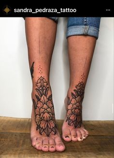 two feet with tattoos on them, one has flowers and the other has birds in it