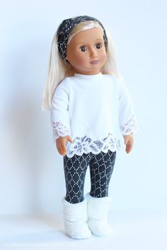 a doll with blonde hair wearing black and white pants, a white shirt and headband