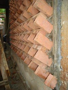 a brick wall that is being built into the side of a building