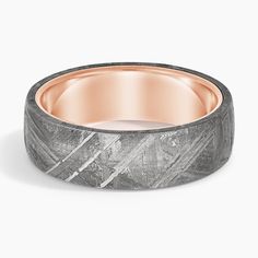 a wedding band that is made out of gold and grey marble