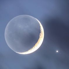 the moon and two stars are visible in the sky