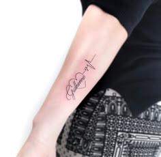 a woman's arm with a tattoo on it