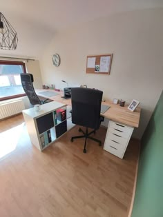 an office with a desk, chair and computer on top of the desk is shown