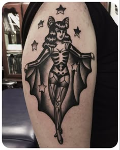 a woman with a bat tattoo on her arm is shown in black and grey colors