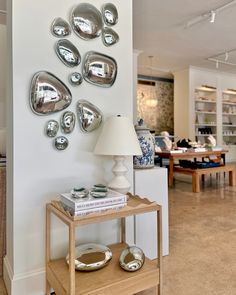 a living room filled with furniture and a wall mounted clock on the side of it