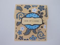 a card with a blue and black design on it that says one of a kind