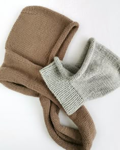 two scarves on top of each other, one in brown and the other in grey