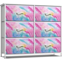 the drawers are painted with pink, blue and yellow paint on it's sides