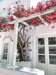 a white building with pink flowers on it