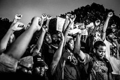 a group of people holding up their hands in the air