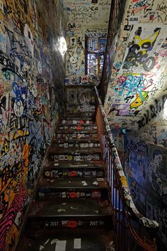 the stairs are covered with graffiti and stickers