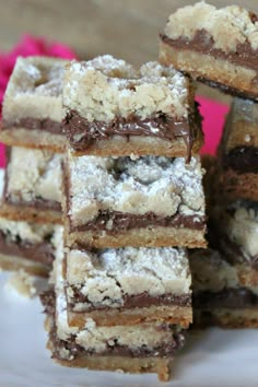 several pieces of cake sitting on top of a white plate