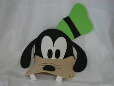 a black and white dog with a green hat on top of it's head