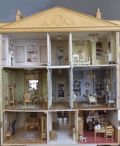 a doll house with all the furniture and accessories in it's display case is shown