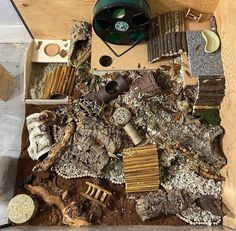 a wooden box filled with lots of different types of items and materials on top of each other