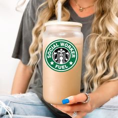 a woman holding a starbucks drink in her hand