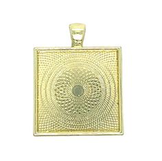 a gold square pendant with an intricate design