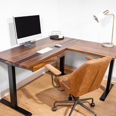 an office desk with a computer on it and a chair in front of the desk