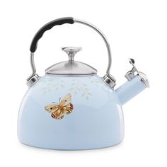 a tea kettle with a butterfly painted on it