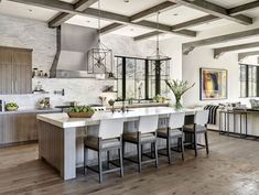 a large kitchen with an island in the middle and lots of counter space on one side