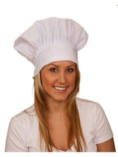 a woman wearing a white chef's hat and smiling at the camera with long blonde hair