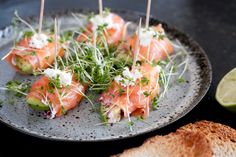 some food is sitting on a plate with toothpicks