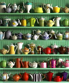 a green shelf filled with lots of different kinds of teapots and coffee cups