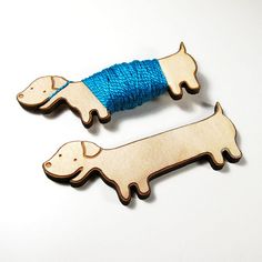 two wooden dachshunds with blue string on them