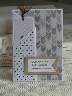 a close up of a card on a bed with books in the background and a tag attached to it