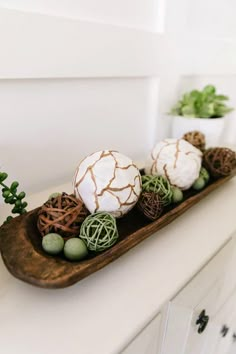 some balls and plants are sitting on a wooden sleigh