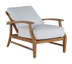 a wooden chair with a white cushion on it's back and armrests