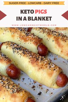 several hotdogs with mustard and sprinkles are on a baking sheet