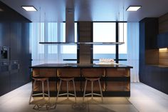 a modern kitchen with an island counter and bar stools next to the window overlooking the ocean