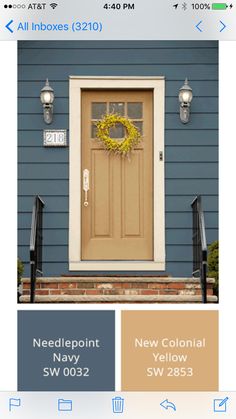 the front door is painted brown and has a yellow wreath hanging from it's side