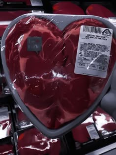 a large heart shaped object is on display in a grocery store, with other items behind it